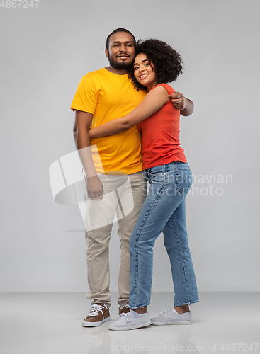 Image of happy african american couple hugging