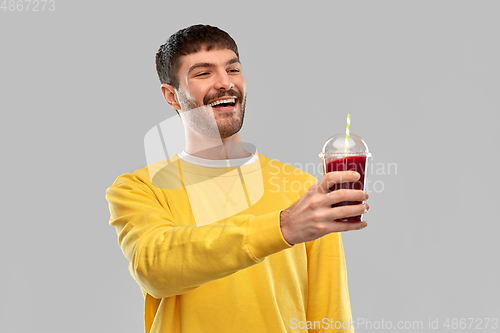 Image of happy man with tomato juice in takeaway cup