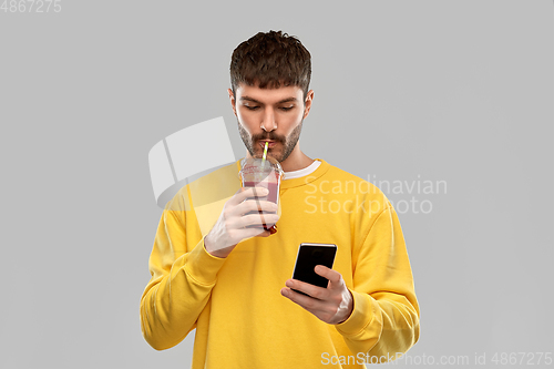 Image of man with smartphone and tomato juice