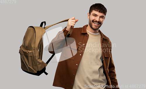 Image of happy smiling young man in glasses with backpack