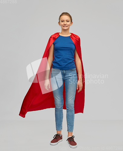 Image of smiling teenage girl in red superhero cape
