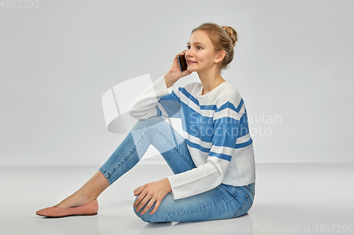 Image of happy smiling teenage girl calling on smartphone