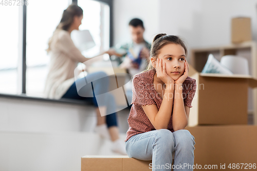 Image of sad girl moving to new home with her family