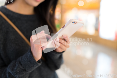 Image of Woman working on mobile phone