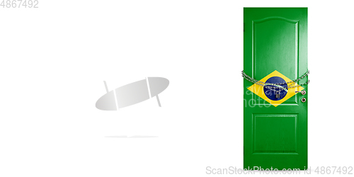 Image of Door colored in Brazil flag, locking with chain. Countries lockdown during coronavirus, COVID spreading