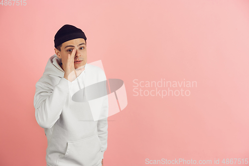 Image of Caucasian young man\'s modern portrait on pink studio background