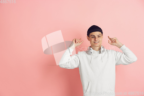 Image of Caucasian young man\'s modern portrait on pink studio background