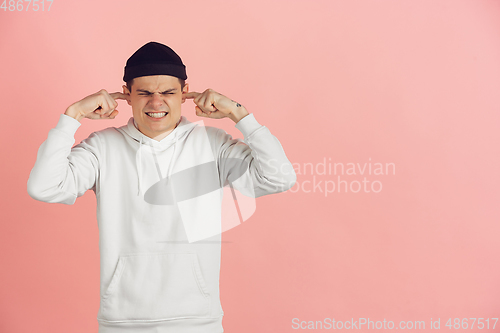 Image of Caucasian young man\'s modern portrait on pink studio background