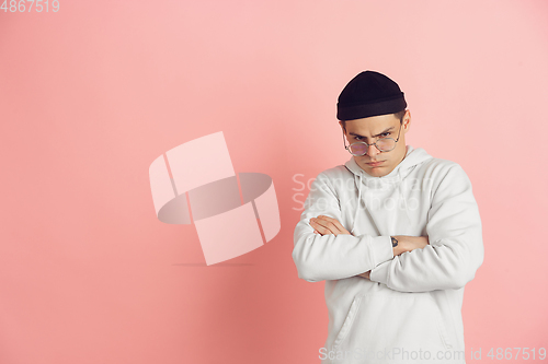 Image of Caucasian young man\'s modern portrait on pink studio background