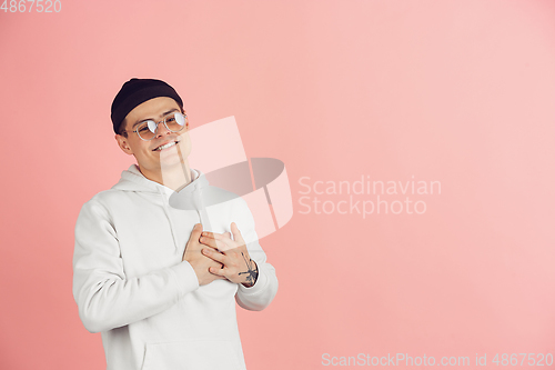 Image of Caucasian young man\'s modern portrait on pink studio background