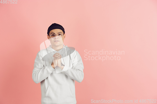Image of Caucasian young man\'s modern portrait on pink studio background