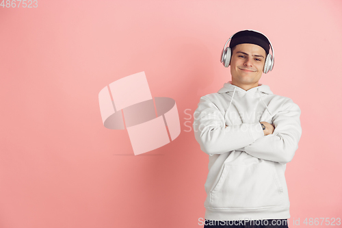 Image of Caucasian young man\'s modern portrait on pink studio background