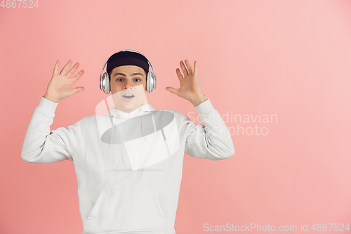 Image of Caucasian young man\'s modern portrait on pink studio background
