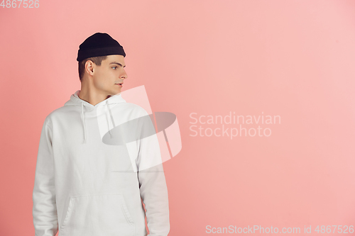Image of Caucasian young man\'s modern portrait on pink studio background