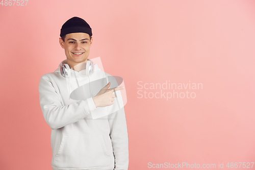 Image of Caucasian young man\'s modern portrait on pink studio background