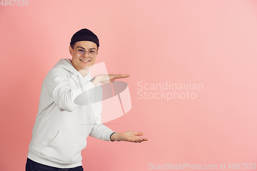 Image of Caucasian young man\'s modern portrait on pink studio background