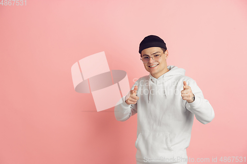 Image of Caucasian young man\'s modern portrait on pink studio background