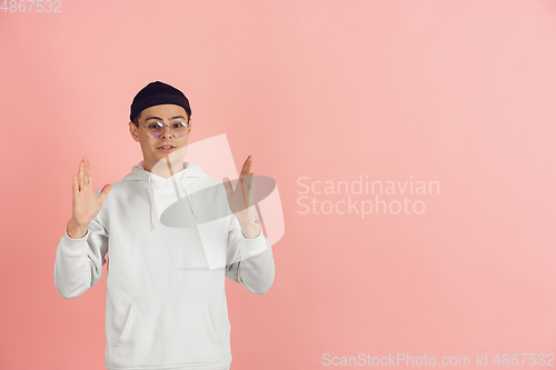 Image of Caucasian young man\'s modern portrait on pink studio background