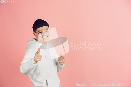 Image of Caucasian young man\'s modern portrait on pink studio background