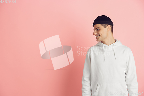 Image of Caucasian young man\'s modern portrait on pink studio background