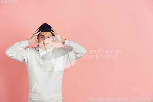 Image of Caucasian young man\'s modern portrait on pink studio background