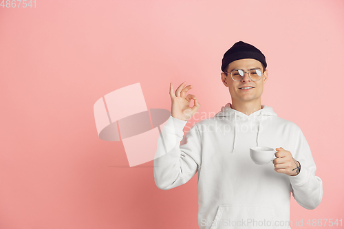 Image of Caucasian young man\'s modern portrait on pink studio background