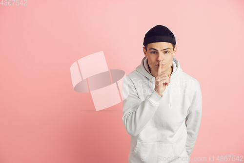 Image of Caucasian young man\'s modern portrait on pink studio background