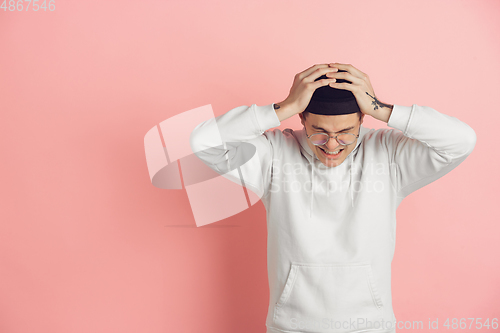 Image of Caucasian young man\'s modern portrait on pink studio background