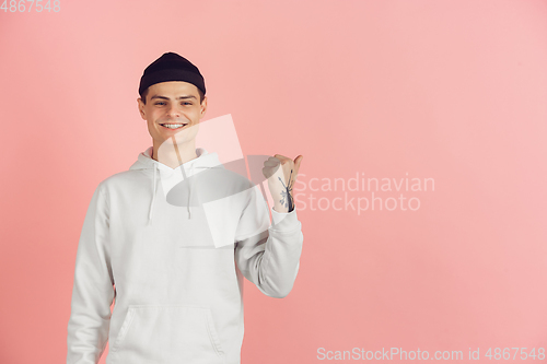 Image of Caucasian young man\'s modern portrait on pink studio background