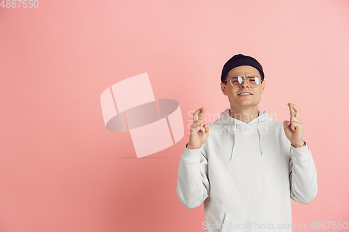 Image of Caucasian young man\'s modern portrait on pink studio background