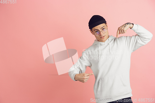 Image of Caucasian young man\'s modern portrait on pink studio background