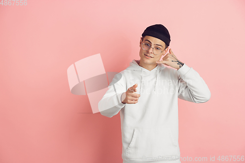 Image of Caucasian young man\'s modern portrait on pink studio background