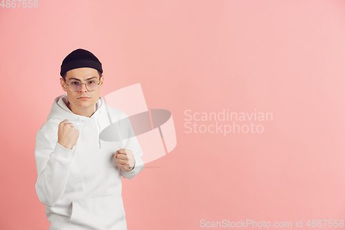 Image of Caucasian young man\'s modern portrait on pink studio background