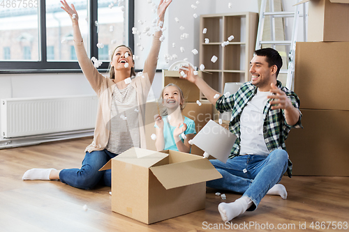 Image of happy family playing with foam peanuts at new home