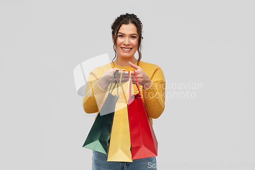 Image of happy smiling young woman with shopping bags