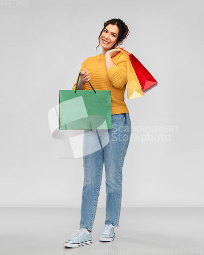 Image of happy smiling young woman with shopping bags