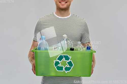 Image of smiling young man sorting plastic waste