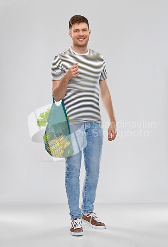 Image of happy man with food in reusable net tote