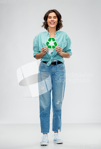 Image of smiling young woman holding green recycling sign
