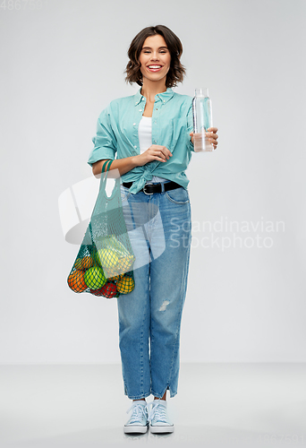 Image of woman with bag for food shopping and glass bottle