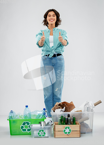 Image of happy woman sorting paper, metal and plastic waste