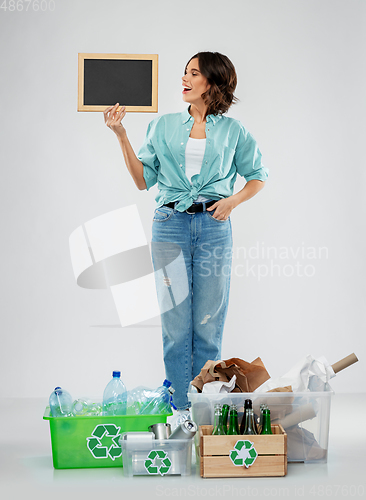 Image of happy woman sorting paper, metal and plastic waste