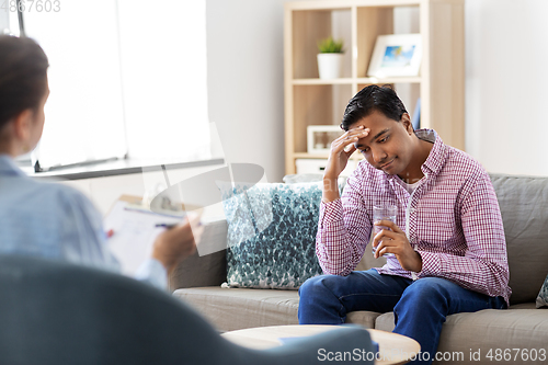 Image of man and psychologist at psychotherapy session