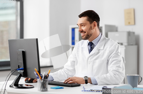Image of male doctor with computer working at hospital