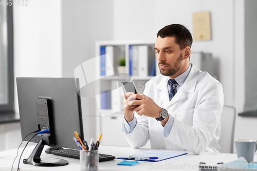 Image of male doctor with smartphone at hospital