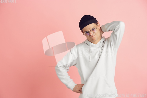 Image of Caucasian young man\'s modern portrait on pink studio background