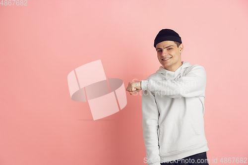 Image of Caucasian young man\'s modern portrait on pink studio background