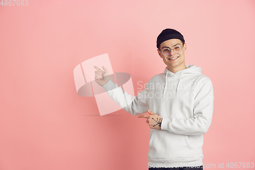 Image of Caucasian young man\'s modern portrait on pink studio background