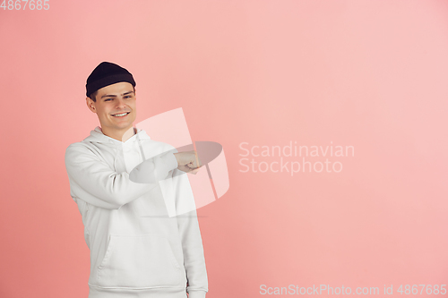 Image of Caucasian young man\'s modern portrait on pink studio background