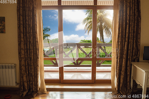 Image of Closed window and beautiful picture outside, nature view, resort and resting